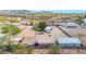 Aerial view showcasing a fenced property with outbuildings, equestrian facilities, and desert landscape at 37508 N 12Th St, Phoenix, AZ 85086