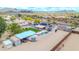 Aerial view of a desert property with a pool, covered parking, and other desert homes in the distance at 37508 N 12Th St, Phoenix, AZ 85086