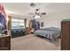 Bedroom with ceiling fan, closet, dresser, and large window at 37508 N 12Th St, Phoenix, AZ 85086