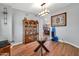 Dining area featuring wood floors, glass table, hutch, and views into the kitchen at 37508 N 12Th St, Phoenix, AZ 85086
