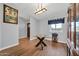 Dining area with a glass table, wood floors, and natural light from the window at 37508 N 12Th St, Phoenix, AZ 85086