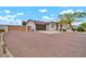 Home with a gated driveway and desert landscaping; solar panels can be seen on the roof at 37508 N 12Th St, Phoenix, AZ 85086