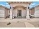 Front porch with detailed columns, decorative light fixtures, and a metal front door at 37508 N 12Th St, Phoenix, AZ 85086