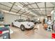 Inside of a spacious garage with a car, buggy, and plenty of room for hobbies at 37508 N 12Th St, Phoenix, AZ 85086