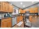 Close up of kitchen with stainless steel appliances, wood cabinets, dark countertops, and backsplash at 37508 N 12Th St, Phoenix, AZ 85086