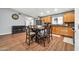 Open kitchen and dining area with wood floors, cabinetry, and stainless steel refrigerator at 37508 N 12Th St, Phoenix, AZ 85086