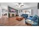 Inviting living room features a brick fireplace, ceiling fan, and comfortable blue sofas at 37508 N 12Th St, Phoenix, AZ 85086