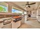 Outdoor kitchen featuring stainless steel appliances, including a grill and griddle, with a cozy fireplace nearby at 37508 N 12Th St, Phoenix, AZ 85086