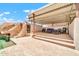 An in-ground pool with adjacent patio and lounge area, complete with a rock slide feature and covered lounge area at 37508 N 12Th St, Phoenix, AZ 85086