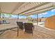 An inviting covered patio with comfortable seating and string lights creates an outdoor oasis overlooking the pool at 37508 N 12Th St, Phoenix, AZ 85086