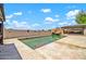 In-ground pool with a unique rock feature, complemented by a spacious patio and comfortable lounge furniture at 37508 N 12Th St, Phoenix, AZ 85086