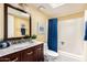 Bathroom featuring a vanity with marble countertop and a tub with blue curtain at 4033 E Larkspur Dr, Phoenix, AZ 85032