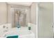 Bright bathroom featuring tub with shower and view to the outdoors at 4033 E Larkspur Dr, Phoenix, AZ 85032