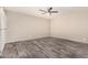 Spacious bedroom with wood-look tile flooring and a modern ceiling fan at 4033 E Larkspur Dr, Phoenix, AZ 85032