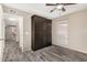 Bedroom featuring a built-in wardrobe, ceiling fan, gray wood-look flooring, and a window at 4033 E Larkspur Dr, Phoenix, AZ 85032