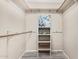 Walk-in closet with shelving, wood-look tile flooring and neutral paint at 4033 E Larkspur Dr, Phoenix, AZ 85032