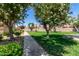 A tree-lined walkway through a community common area features lush greenery, providing a scenic and inviting atmosphere at 4033 E Larkspur Dr, Phoenix, AZ 85032