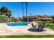 A community swimming pool with a stone deck features tables and chairs, perfect for enjoying the sun and socializing at 4033 E Larkspur Dr, Phoenix, AZ 85032