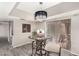 Cozy dining area featuring a glass table, chandelier, and sliding glass doors to an outdoor area at 4033 E Larkspur Dr, Phoenix, AZ 85032
