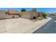 Home exterior features a two-car garage, large driveway, and low-maintenance landscaping at 4033 E Larkspur Dr, Phoenix, AZ 85032