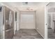 Bright kitchen with stainless steel fridge, ceiling fan, and wood-look tile flooring at 4033 E Larkspur Dr, Phoenix, AZ 85032