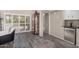 Open living space featuring wood-look tile and a mini fridge for entertaining at 4033 E Larkspur Dr, Phoenix, AZ 85032