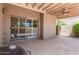 Covered patio with a ceiling fan, grill, and sliding glass doors to the interior at 4033 E Larkspur Dr, Phoenix, AZ 85032