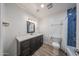 Bright bathroom featuring white countertops, blue tiled shower and updated fixtures at 4102 W Maryland Ave, Phoenix, AZ 85019
