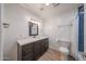 Clean bathroom with white countertop, blue tiled shower and updated fixtures at 4102 W Maryland Ave, Phoenix, AZ 85019