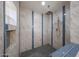Modern shower with blue tile accents, a rainfall showerhead, and a tiled niche for storage at 4102 W Maryland Ave, Phoenix, AZ 85019