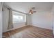 This bedroom features a ceiling fan, window, and wood-look floors at 4102 W Maryland Ave, Phoenix, AZ 85019