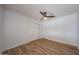This bedroom features wood-look floors, a ceiling fan, closet, and neutral walls at 4102 W Maryland Ave, Phoenix, AZ 85019