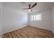 This bedroom offers neutral walls, tile floors, and a bright window with natural light at 4102 W Maryland Ave, Phoenix, AZ 85019