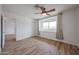 This bedroom includes a closet, a window bench, and wood-look flooring for a modern design at 4102 W Maryland Ave, Phoenix, AZ 85019