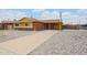 A single-story brick home with yellow trim and low-maintenance rock front yard at 4102 W Maryland Ave, Phoenix, AZ 85019