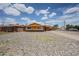 A single-story brick home with yellow trim featuring a low-maintenance rock front yard at 4102 W Maryland Ave, Phoenix, AZ 85019