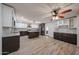 A modern kitchen with white and dark cabinets, stainless steel appliances, and a large island at 4102 W Maryland Ave, Phoenix, AZ 85019