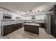 Spacious kitchen featuring a center island, stainless steel appliances, granite counters, and tiled backsplash at 4102 W Maryland Ave, Phoenix, AZ 85019