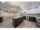 Open concept kitchen with island, flowing into living space with wood ceiling accent at 4102 W Maryland Ave, Phoenix, AZ 85019