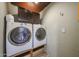 Image shows a practical laundry room space with a washer, dryer, and cabinets at 4102 W Maryland Ave, Phoenix, AZ 85019