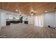 A spacious open-concept living area with wood-look tile floors and a stylish wood plank ceiling at 4102 W Maryland Ave, Phoenix, AZ 85019