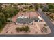 Expansive aerial view of estate featuring pool, tennis court, mature landscaping, and circular driveway at 4107 E Fairview Cir, Mesa, AZ 85206