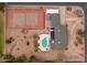 Overhead aerial view of property with pool, tennis court, cabana, and circular driveway at 4107 E Fairview Cir, Mesa, AZ 85206