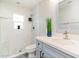 Modern bathroom with white tile and a vanity with quartz countertops and under sink storage at 4107 E Fairview Cir, Mesa, AZ 85206