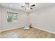 Bright bedroom with wood-look floors, ceiling fan, and natural light from a large window at 4107 E Fairview Cir, Mesa, AZ 85206