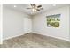 Bedroom with a window view and a closet that features wood-look tile flooring and a ceiling fan at 4107 E Fairview Cir, Mesa, AZ 85206