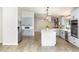 Bright, open kitchen features stainless appliances, modern cabinetry, an island and wood floors at 4107 E Fairview Cir, Mesa, AZ 85206