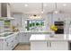 Sunlit kitchen with stainless appliances, modern cabinetry, and a window overlooking the pool area at 4107 E Fairview Cir, Mesa, AZ 85206