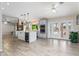 Spacious, open kitchen with stainless appliances, a large island, wood flooring and french doors to the outdoor living space at 4107 E Fairview Cir, Mesa, AZ 85206