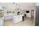 Bright kitchen with stainless appliances, modern cabinetry, island, wine fridge, and wood flooring at 4107 E Fairview Cir, Mesa, AZ 85206